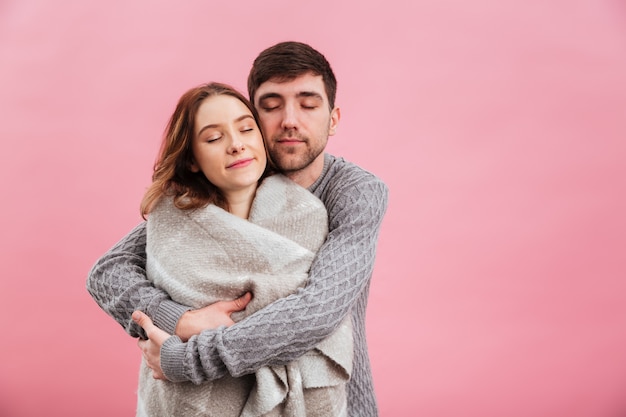 Retrato de joven pareja amorosa vestida con suéteres