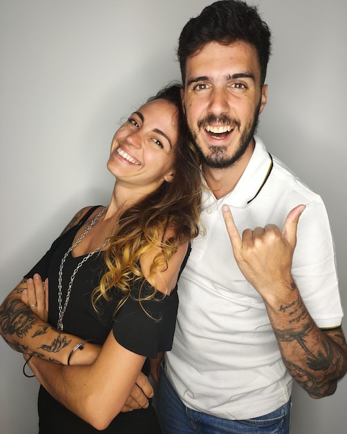 Foto retrato de una joven pareja sonriente de pie contra un fondo blanco