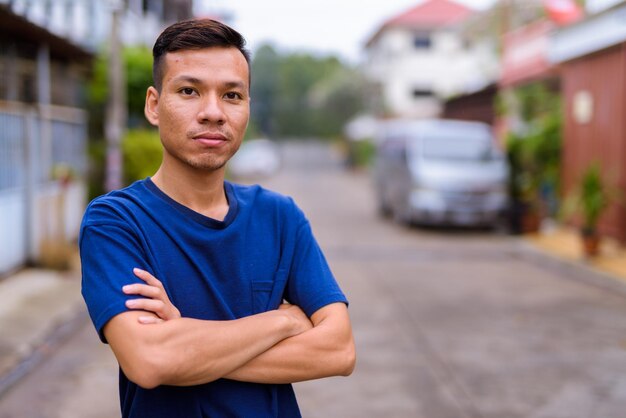 Foto retrato de un joven de pie en la calle