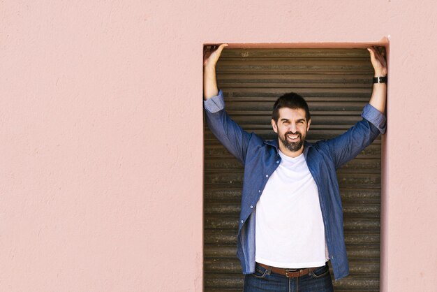 Foto retrato de un joven de pie contra la pared