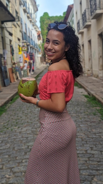 Foto retrato de una joven sonriente en la ciudad