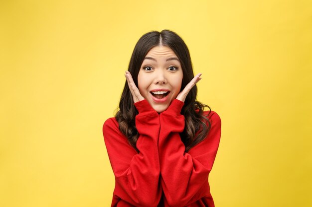 Foto retrato de una joven sonriente contra un fondo amarillo