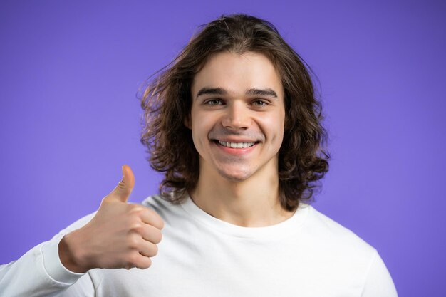 Foto retrato de una joven sonriente contra un fondo azul