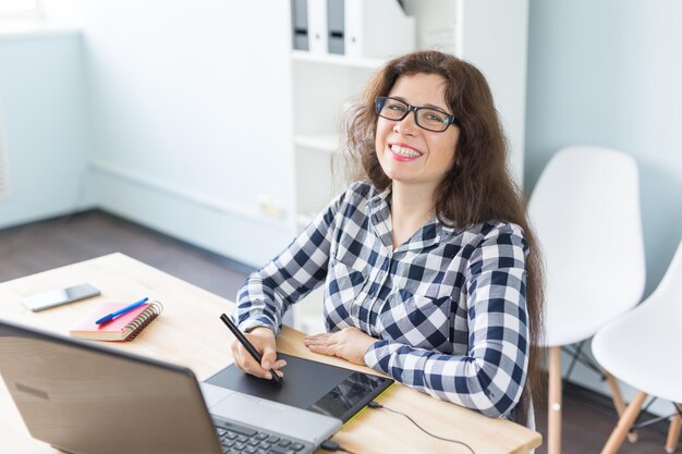 Retrato de una joven sonriente sentada en la mesa