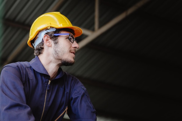 Retrato de joven trabajador estadounidense feliz en ropa de seguridad casco de casco de ingeniero con espacio de copia