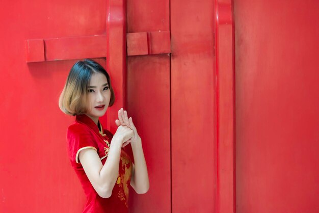 Retrato linda mulher asiática no vestido cheongsampovo da tailândiafeliz ano novo chinêsconceitofeliz senhora asiática no vestido tradicional chinês