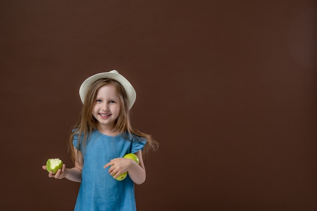 Retrato de una linda niña comiendo una manzana