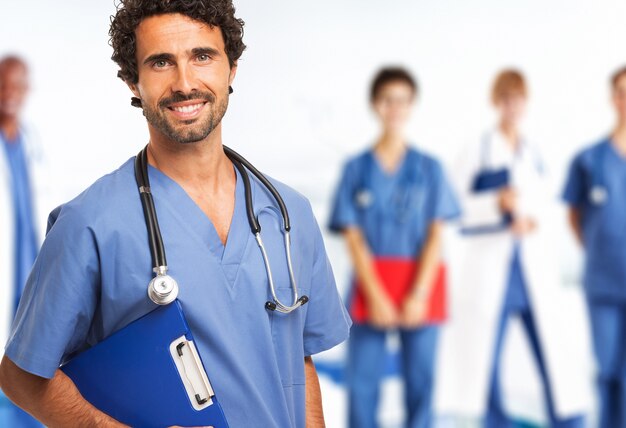 Retrato de un médico sonriente frente a su equipo médico