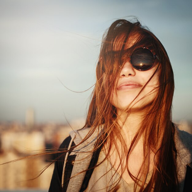 Retrato de moda de mujer joven con gafas de sol