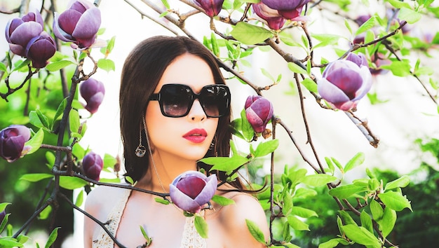 Retrato de modelo de belleza con gafas de sol Retrato de rostro de mujer de belleza en flor de magnolia