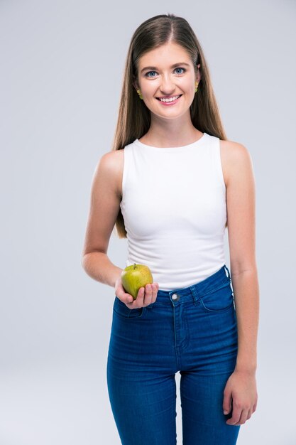 Retrato de una mujer adolescente feliz sosteniendo apple aislado