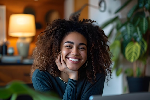 Retrato de una mujer afroamericana sonriente usando una computadora portátil en casa