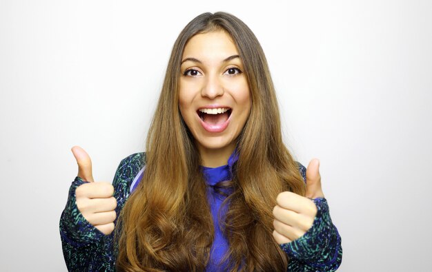 Retrato de mujer alegre mostrando los pulgares para arriba