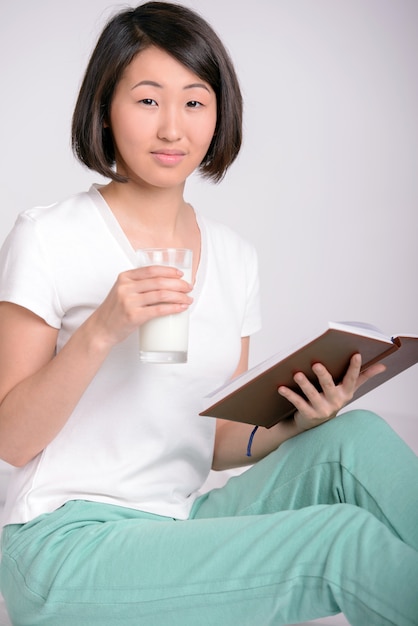 Retrato de mujer asiática, centros turísticos y lee un libro.