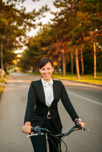 Retrato de una mujer elegante en una bicicleta. Mirando a la camara