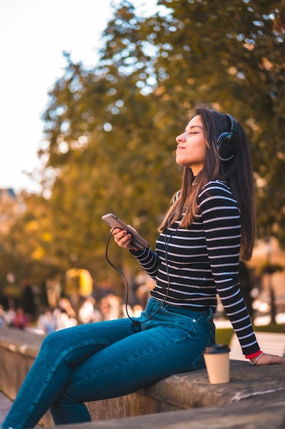 retrato, mujer, escuchar música, en el estacionamiento