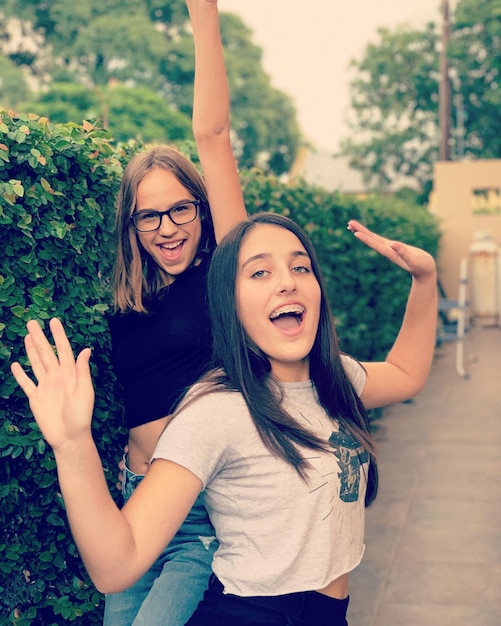 Foto retrato de una mujer feliz con los brazos levantados