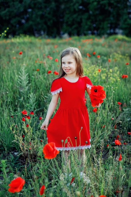 Foto retrato de mujer con flores rojas en el campo