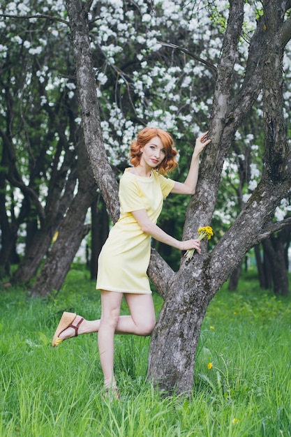 Retrato de mujer hermosa en jardín floreciente de primavera