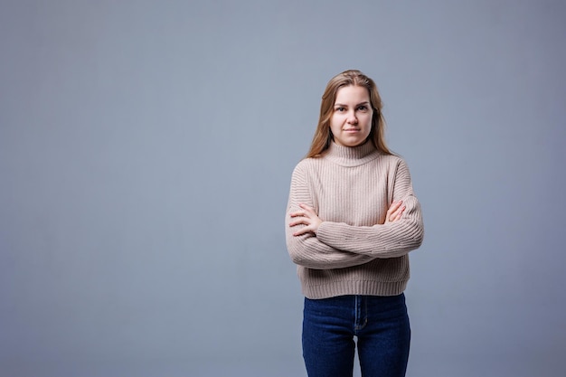 Retrato de una mujer joven alegre aislado fondo de pared gris Emociones humanas positivas expresiones faciales Concepto de publicidad satisfacción del cliente