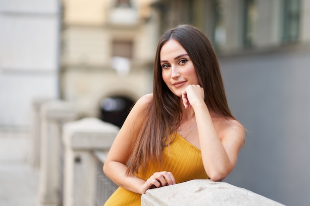 Retrato de una mujer joven y bonita vestida de moda mirando a la cámara