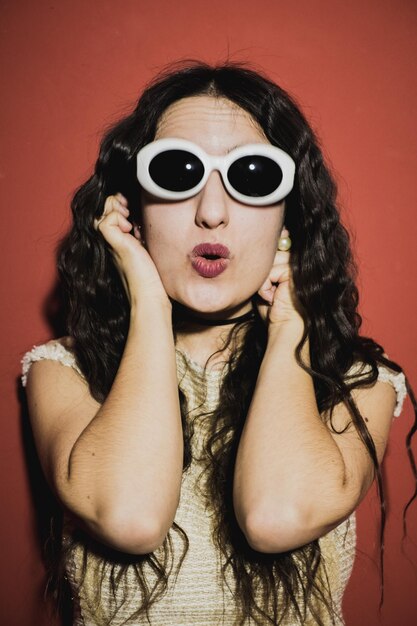 Foto retrato de una mujer joven con gafas de sol