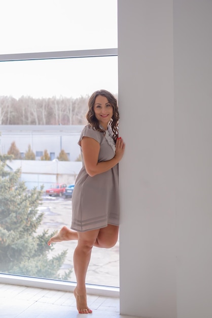 retrato de una mujer joven y hermosa en un elegante interior moderno cerca de la ventana