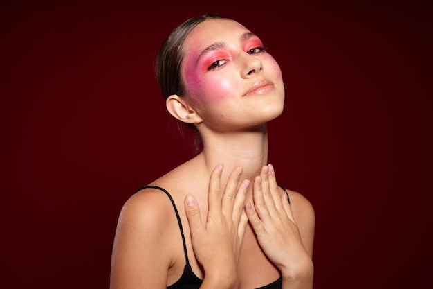 Retrato de mujer joven hermosa maquillaje emociones cosméticos cuidado del cabello rímel rosa fondo inalterado