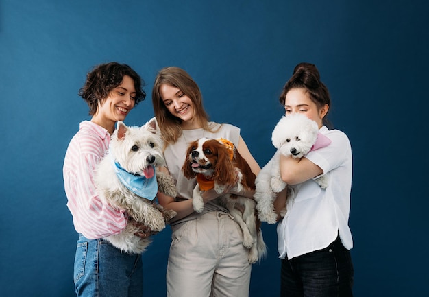 Foto retrato de una mujer joven con un perro contra un fondo blanco