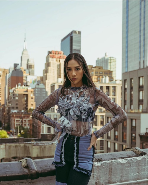 Foto retrato de una mujer joven de pie contra un edificio