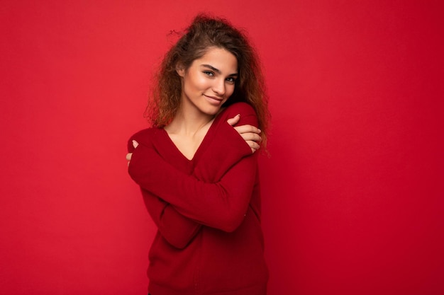 Retrato de una mujer joven de pie contra un fondo amarillo