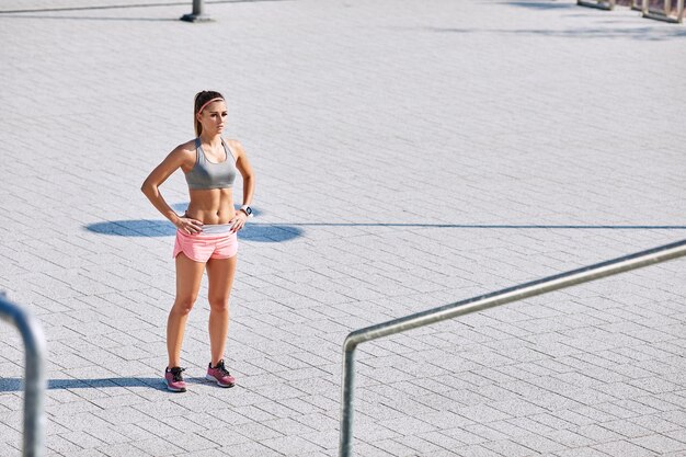 Retrato de mujer joven preparándose para hacer ejercicio al aire libre