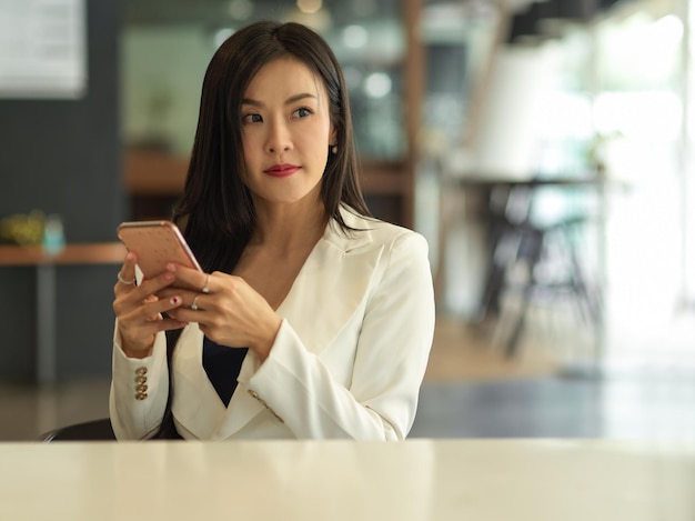 Retrato de una mujer joven usando un teléfono inteligente