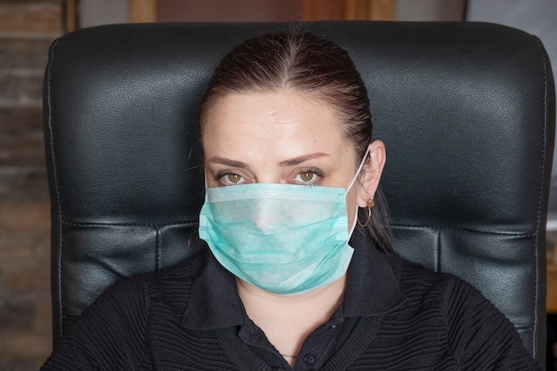 Retrato de una mujer en mascarilla médica en el trabajo