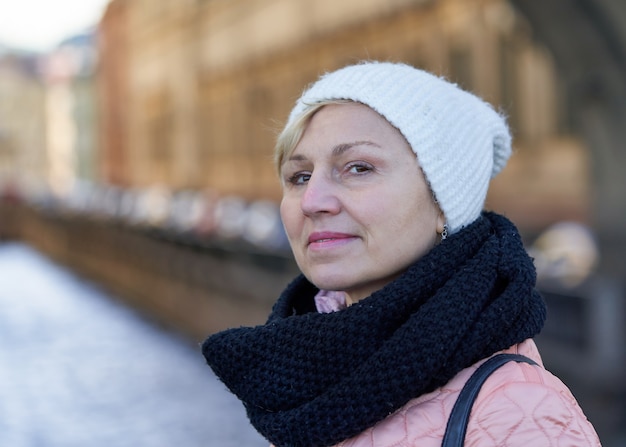 Retrato de una mujer de mediana edad con una bufanda y un sombrero