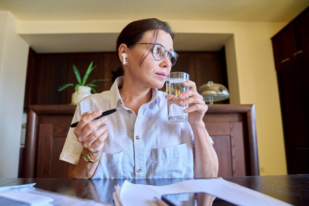 Retrato de mujer de negocios en auriculares mirando el primer plano de la cara de la cámara web