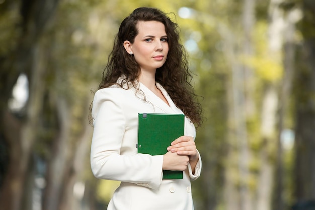 Retrato de una mujer de negocios con un cuaderno en la mano.