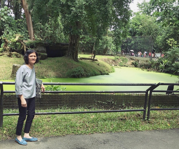 Foto retrato de una mujer de pie en un parque