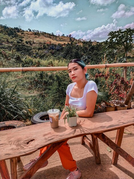 Foto retrato de una mujer sentada en una mesa