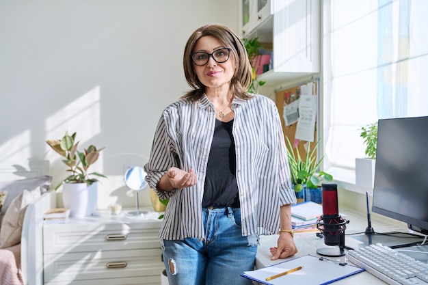 Retrato de mujer sonriente madura mirando a la cámara en casa