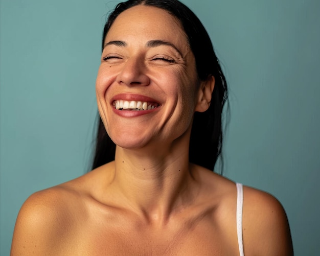 Retrato de una mujer sonriente sobre un fondo azul foto de archivo