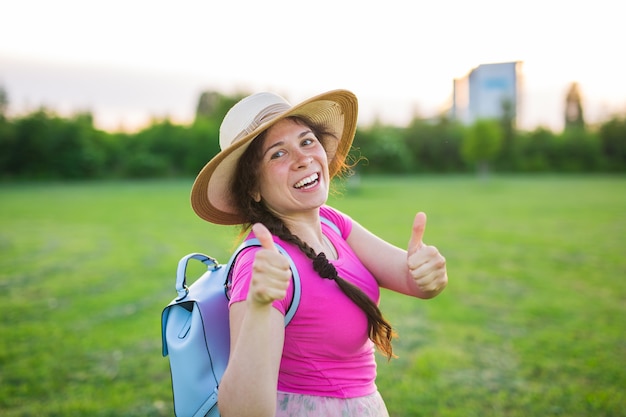 Retrato de mujer sorprendida o riendo gracioso lindo con mochila y sombrero