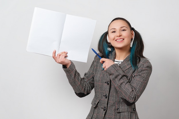 Retrato de una mujer, sosteniendo un cuaderno con un copyspace y muestra la pluma.