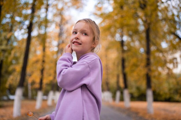 Retrato de una niña feliz en la temporada de otoño del parque amarillo