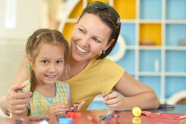 Retrato de una niña jugando con la madre en casa