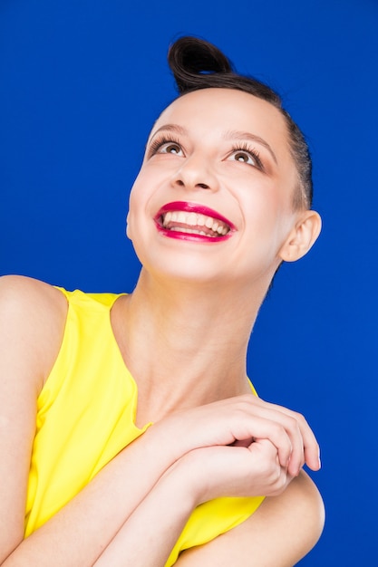 Retrato de niña con maquillaje en vestido amarillo