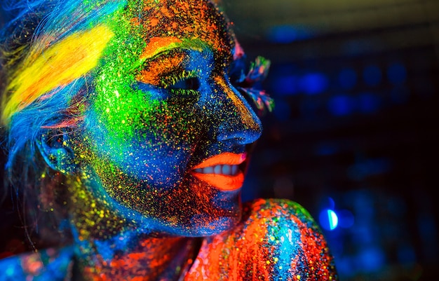 Retrato de una niña pintada en polvo fluorescente.