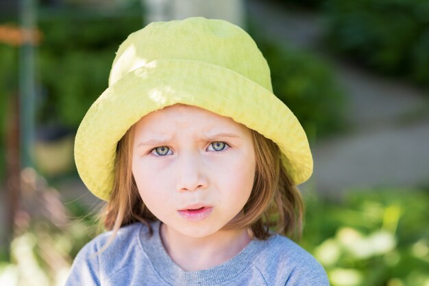 Retrato de niña triste en el parque de verano