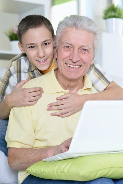 retrato, de, niño, y, abuelo, con, un, computador portatil, en casa