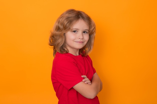 Retrato de niño divertido con los brazos cruzados sobre fondo de estudio aislado niño feliz feliz y sonriente